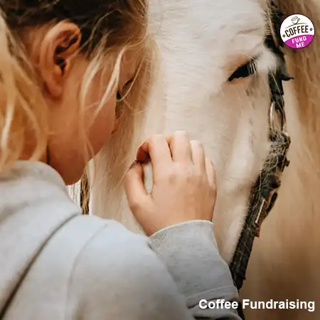 A young rider next to her horse, who just learned how to raise funds for her local equestrian club.